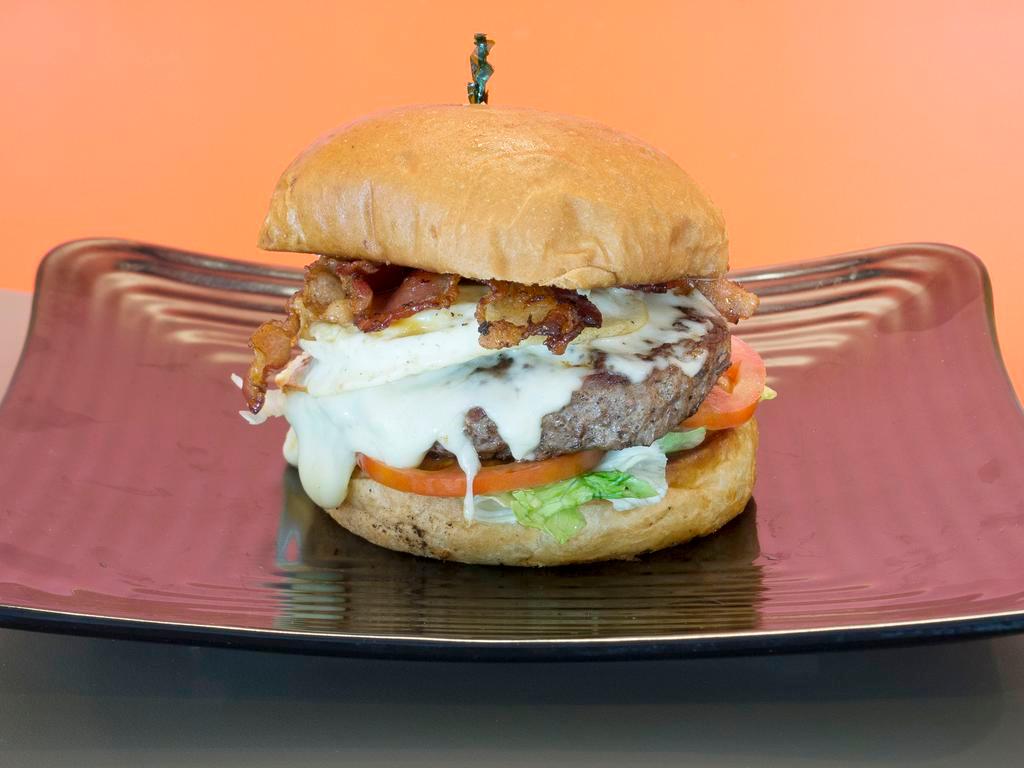 The Knockout Burger · 1/2 lb. all-natural beef burger with mozzarella, bacon, fried egg, basil mayo, lettuce, and tomatoes.