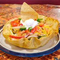 Taco Salad · Crispy flour tortilla shell layered with lettuce, rice, cheese, tomatoes, red and green bell...