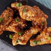 Soy Garlic Wings · Not spicy. Soy garlic glazed wings topped with sesame seeds and green onions.