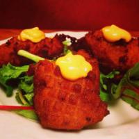 Sweet Potato Fritters  · Crispy fritters with corn and glazed with spicy chipotle mayo.