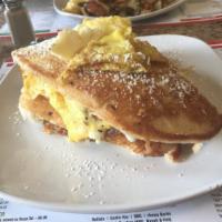 Da Bomb (Omelet Stuffed Pancake) · Bacon, egg and cheese omelet stuffed inside a giant pancake. Served with syrup. 