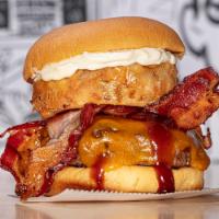 THE TEXAN BURGER · prime burger, bacon, aged cheddar, crispy onion ring, sweet baby rays bbq & mayo on a potato...