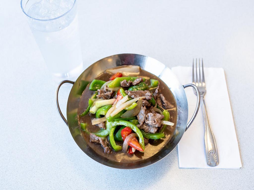 13. Pepper Steak · Beef stir fried with bell peppers and yellow and green onions. Served with steamed rice