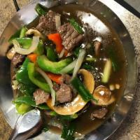 15. Oyster Beef · Stir fried beef in oyster sauce with mushrooms, bell peppers and onions. Served with steamed...
