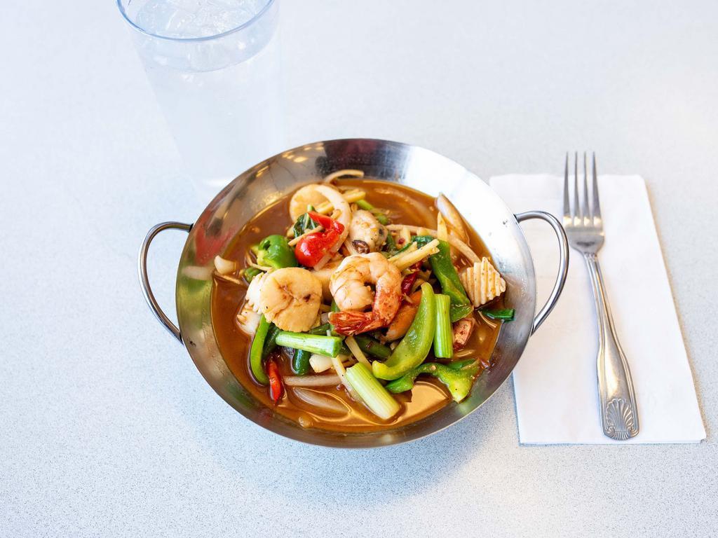 17. Spicy Seafood Deluxe · Shrimp, squid, mussels, crab meat and scallops sauteed with chili, bamboo shoots, garlic, green beans, bell peppers and basil leaves. Served with steamed rice. Spicy.