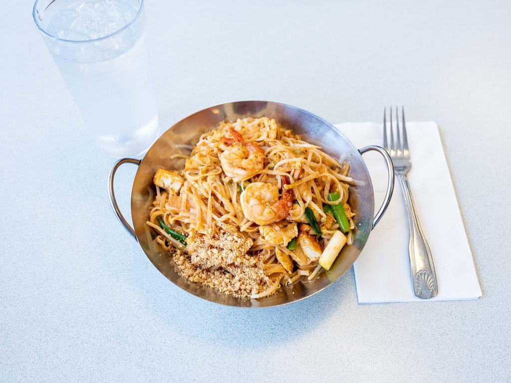 24. Phad Thai · Stir fried rice noodles with shrimp, chicken, tofu, crushed peanuts, bean sprouts, green onions and egg.
(with lime per request only)