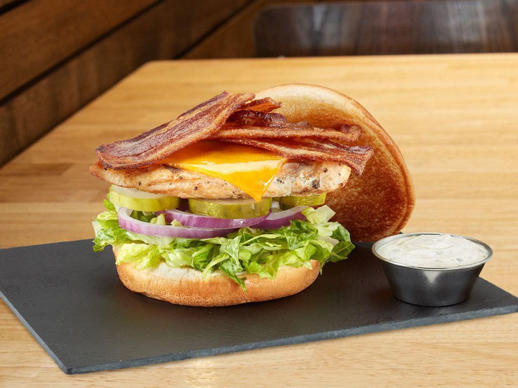 Chicken Bacon Ranch · Served with grilled chicken breast, bacon, cheddar, lettuce blend, red onions, pickles, and ranch with a plain bun.