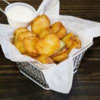 Fried Pickles · Sliced pickles breaded and fried golden and crispy on the outside served with a side of ranch.