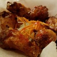 8. Six Piece Racha Chicken Wings · Deep fried marinated chicken wings with sweet chili sauce or Sriracha sauce. Mild spicy.