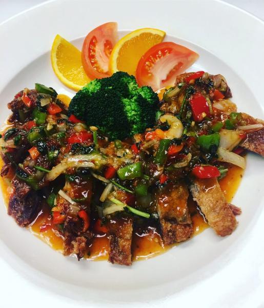 62. Ped Lad Prik · Roasted duck topped with sweet chili sauce, onion, red and green bell pepper and cilantro. Medium spicy.