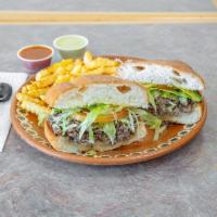 Fajita Torta · Fajita meat on a mexican bread, cheese, avocado, lettuce, tomatoes, sour cream or mayo. Serv...