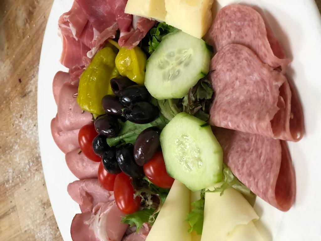 Antipasto Assortito · Mortadella, capicola, salami, ham, provolone, Kalamata olives, pepperoncini, and tomatoes served on a bed of romaine lettuce with Italian dressing.
