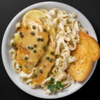Chicken Piccata · 2 chicken breast sauteed in a lemon white wine butter sauce with capers, served with fettucc...