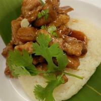 Grilled Pork and Sticky Rice · Marinated and grilled pork, served with sticky rice.