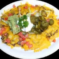 Shrimp Nachos · Corn tortilla chips topped with beans and cheese. Served with guacamole, jalapenos and sour ...