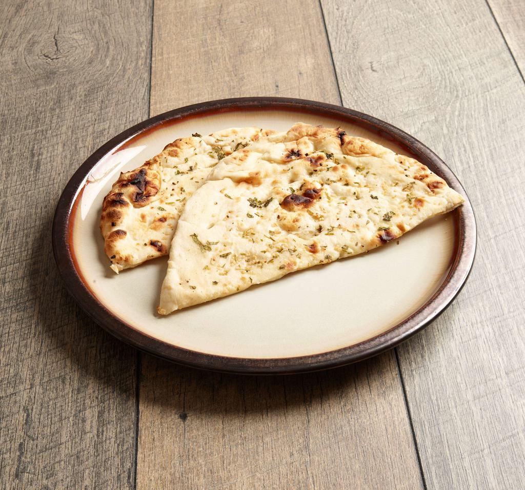 Garlic Naan · Tandoor baked garlic bread.