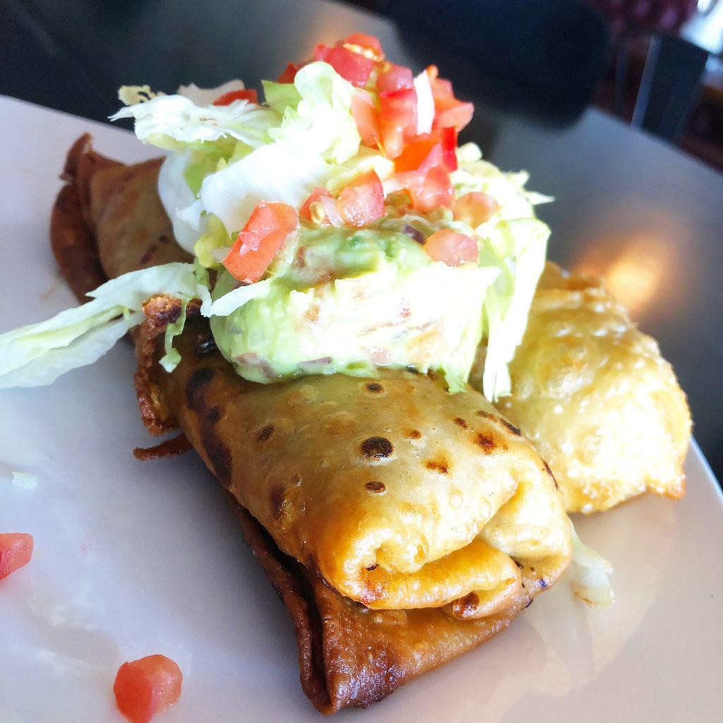 Chicken Chimichanga · (2) Deep Fried Mini Burritos stuffed with Hatch Green Chile Chicken & Cheese. Served with a  side of Sour Cream, Guacamole and Frijoles.
