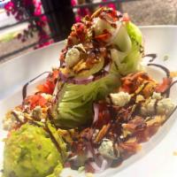 Southwest Wedge · Iceberg wedge topped with smoked bacon, blue cheese crumbles, red onion, diced tomato, guaca...