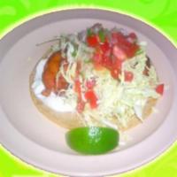 Fish Taco · White sauce, cabbage, onions, tomatoes, and cilantro.