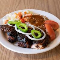 Jerked Chicken Dinner · Marinated leg and thigh of the chicken glazed with homestyle Jerk sauce.
