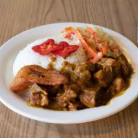Curry Goat Dinner · Curry stewed goat meat simmered to tenderness.
