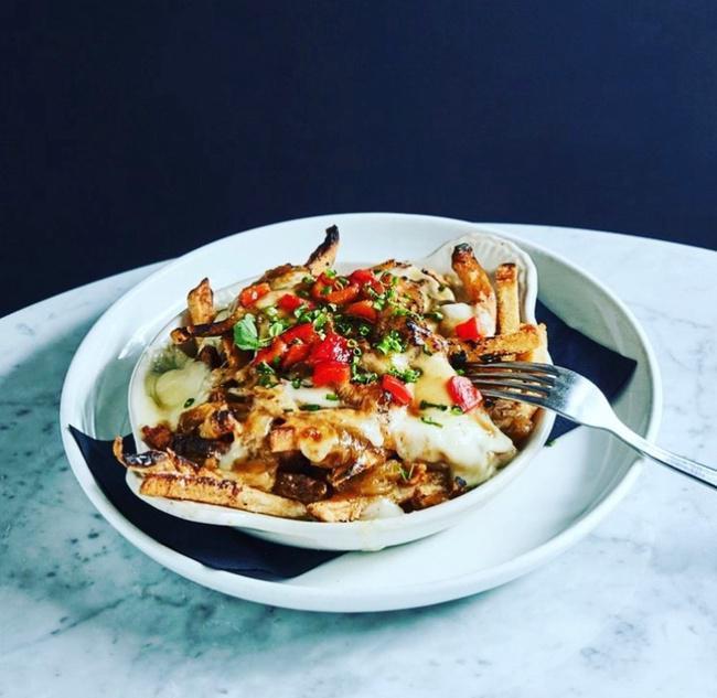 Provençale Poutine · Home cut frites, Canadian bacon, Caramelized onions & peppers, Québec cheese curds, Brown gravy