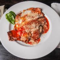 Eggplant Parmigiana · Double stacked, breaded & pan-fried served in our house marinara sauce topped with fresh moz...