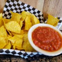 Chips and Salsa · A basket of tortilla chips served with Pop’s homemade salsa.