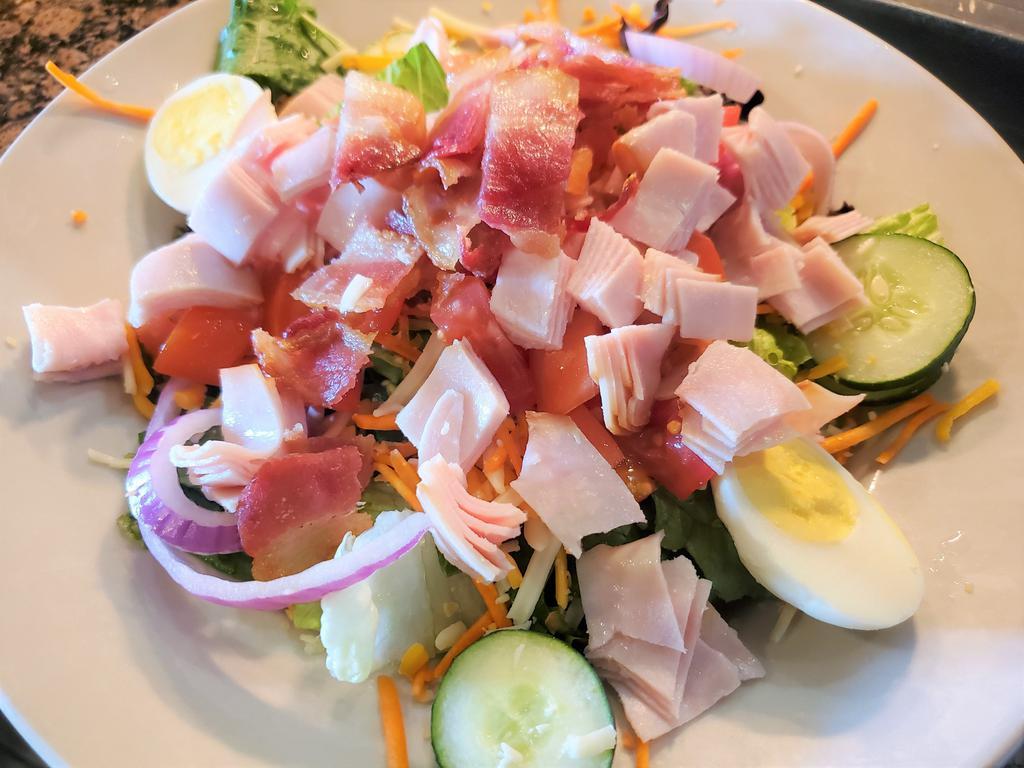 Turkey Bacon Salad · Mixed greens topped with smoked turkey, bacon cheddar-jack cheese, shredded carrots, sliced cucumbers, boiled egg, red onion & diced tomatoes with your choice of dressing