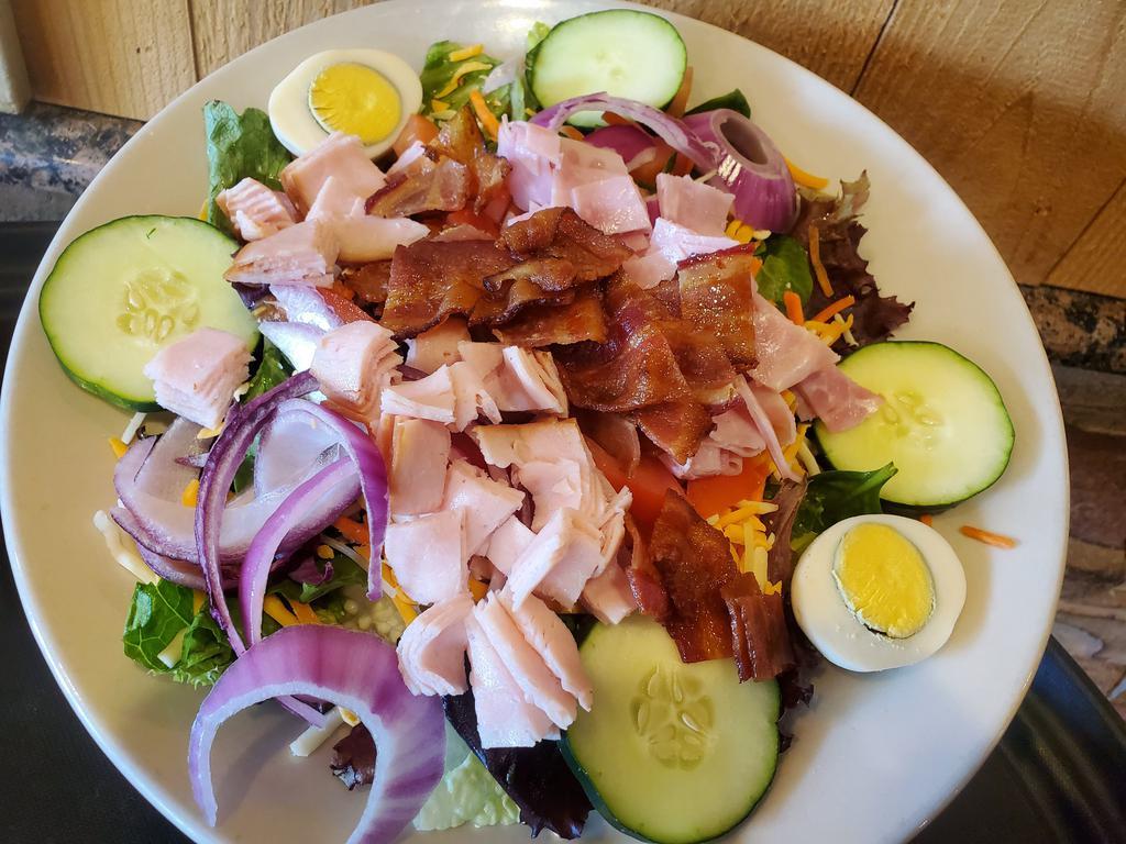 Chef Salad · Mixed greens topped w/ diced smoked turkey breast, smoked ham, crisp bacon, shredded carrots, cheddar-jack cheese, diced tomato, sliced cucumber, red onion & boiled egg