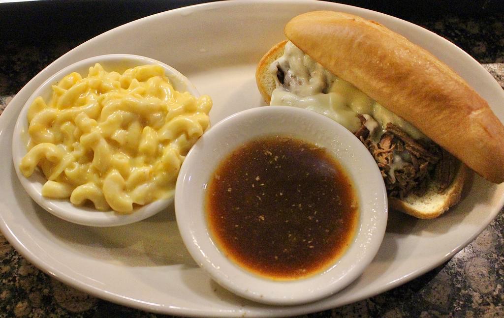 Country Dip · Tender shreds of beef roast topped with melted provolone cheese, served on a toasted hoagie bun with a side of au jus; served with a side