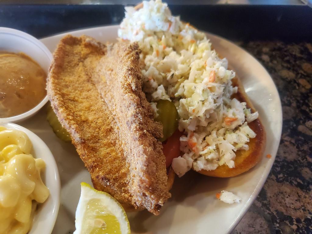 Catfish Sandwich · Grilled or fried catfish filet served on a toasted hoagie w/ pickle, tomato, our homemade slaw & choice of sauce