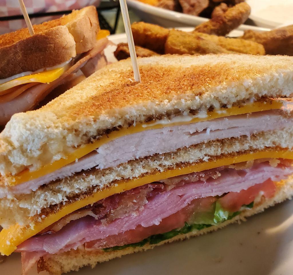 Club · Your traditional club! Sliced turkey & ham served on your choice of toasted white or wheat bread w/ crisp bacon, cheddar cheese, lettuce, tomato & mayo