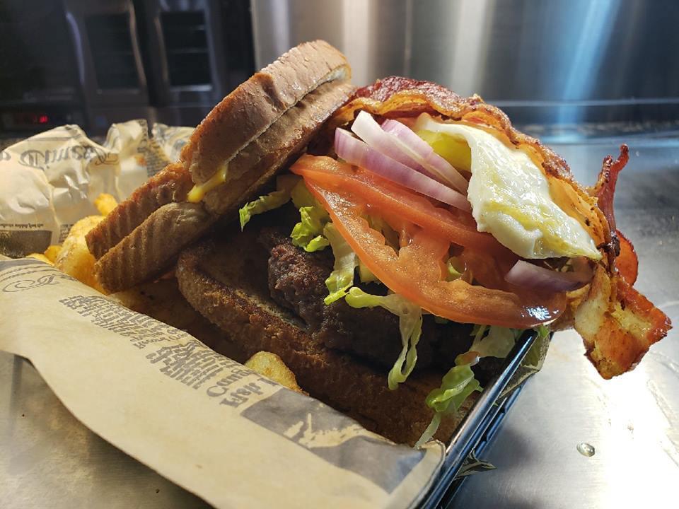 Chuck Burger · Hand-pattied burger grilled to perfection w/ sliced bacon, fried egg, lettuce, tomato, red onion & served between two grilled cheese 