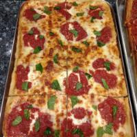 Grandma Pizza · Made of homemade marinara sauce ,fresh mozzarella cheese ,Parmesan,oil,fresh ,basil.