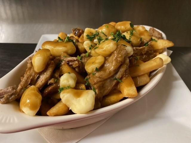 Notorious P.I.G Poutine · French fries, cheese curds, pulled pork, drunken Guinness gravy.
