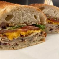 The Jive Turkey Sandwich · Turkey, bacon, cheddar, lettuce, tomato, and a house-made 
cranberry mayo. Served on a soft,...