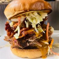 Meat Sweats Sandwich · Beef brisket, pulled pork, bacon, house-made slaw,
and Carolina BBQ. Served on a soft, grill...