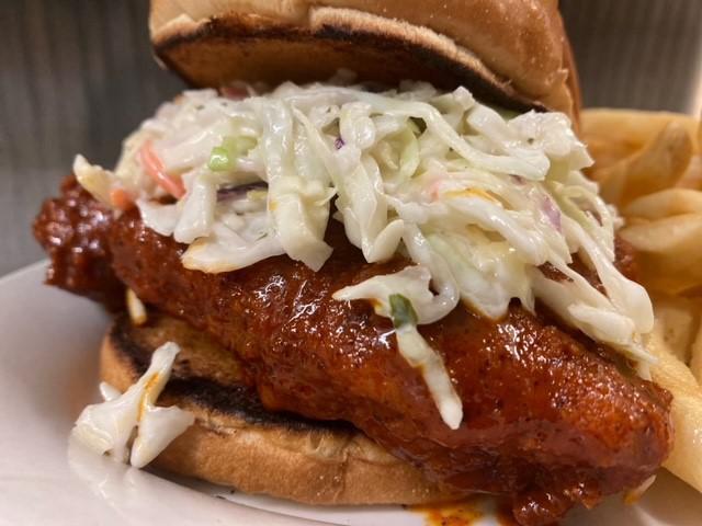 Fire In The Hole · Fried chicken dipped in our Nashville hot sauce and topped 
with coleslaw. Served on a soft, grilled brioche roll.