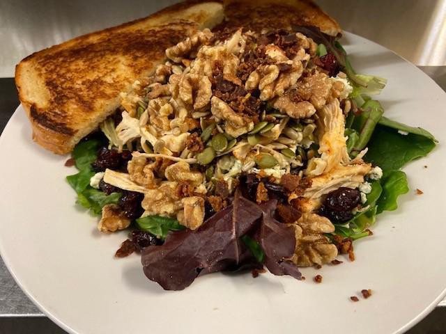 Cape Codder Salad · Salad greens, bacon, crumbly blue, dried craisins, pumpkin 
seeds, sunflower seeds, walnuts, and grilled chicken.
sorry no sides with salads
