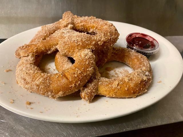 Cinnamon Sugar Pretzels · Two large pub style soft pretzels dipped in our very own brown/white sugar cinnamon blend and served with a side of our delicious raspberry sauce.   