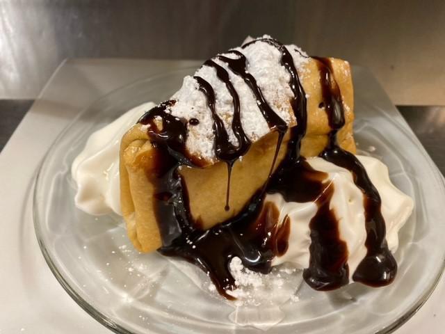 Deep Fried Cheese Cake · We start with our creamy cheese cake , wrap it in a tortilla shell and deep fry it to perfection, we top it with powdered sugar, whipped cream & choice of chocolate syrup or Raspberry sauce.
this dessert is a slice of Heaven !