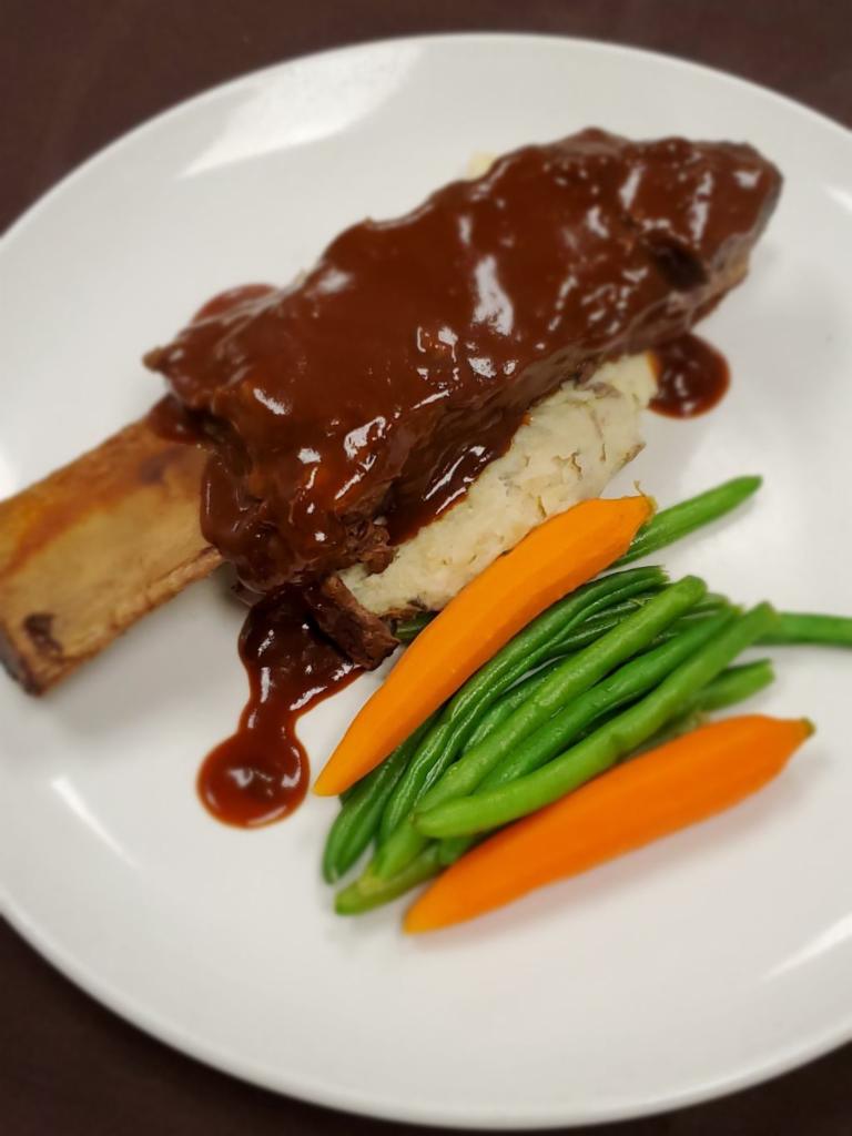 Braised Beef Short Rib · Roasted garlic mashed potato, green beans, baby carrots and demi.