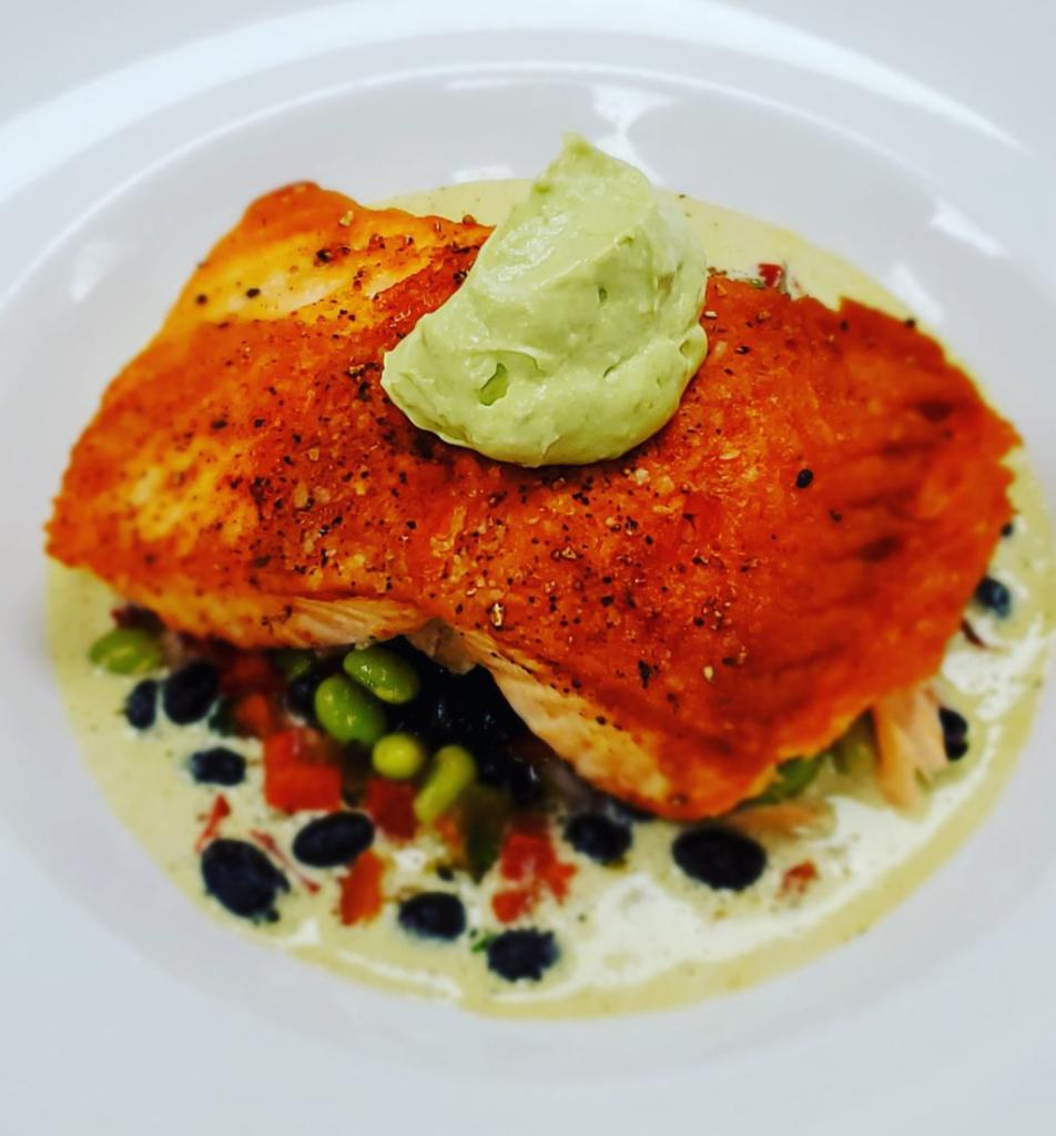 Pan Seared Salmon · Black bean edamame salad, whipped avocado and charred poblano butter.