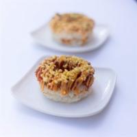 Spicy Tuna Donut · Spicy tuna donut with eel sauce and spicy mayo. Topped With tempura flakes.