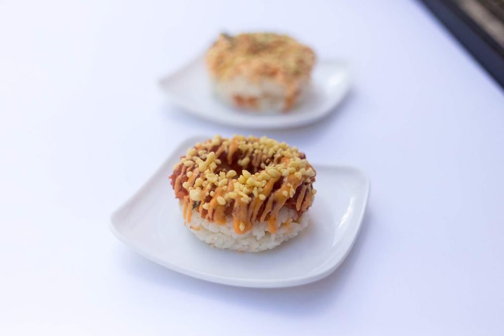 Spicy Tuna Donut · Spicy tuna donut with eel sauce and spicy mayo. Topped With tempura flakes.