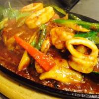 51. Talay Hot Platec · Combination of prawns, scallop, calamari, fish and mussel sauteed in garlic spicy sauce.