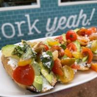Avocado Love · Our version of avocado toast with heirloom tomatoes, and Parmesan.