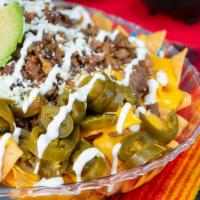 Nachos · Homemade chips, nacho cheese, meat choice, Mexican sour cream, jalapenos.