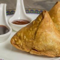Samosa (2 Pieces) ·  fried pastry with a savoury filling, with spiced potatoes and peas.